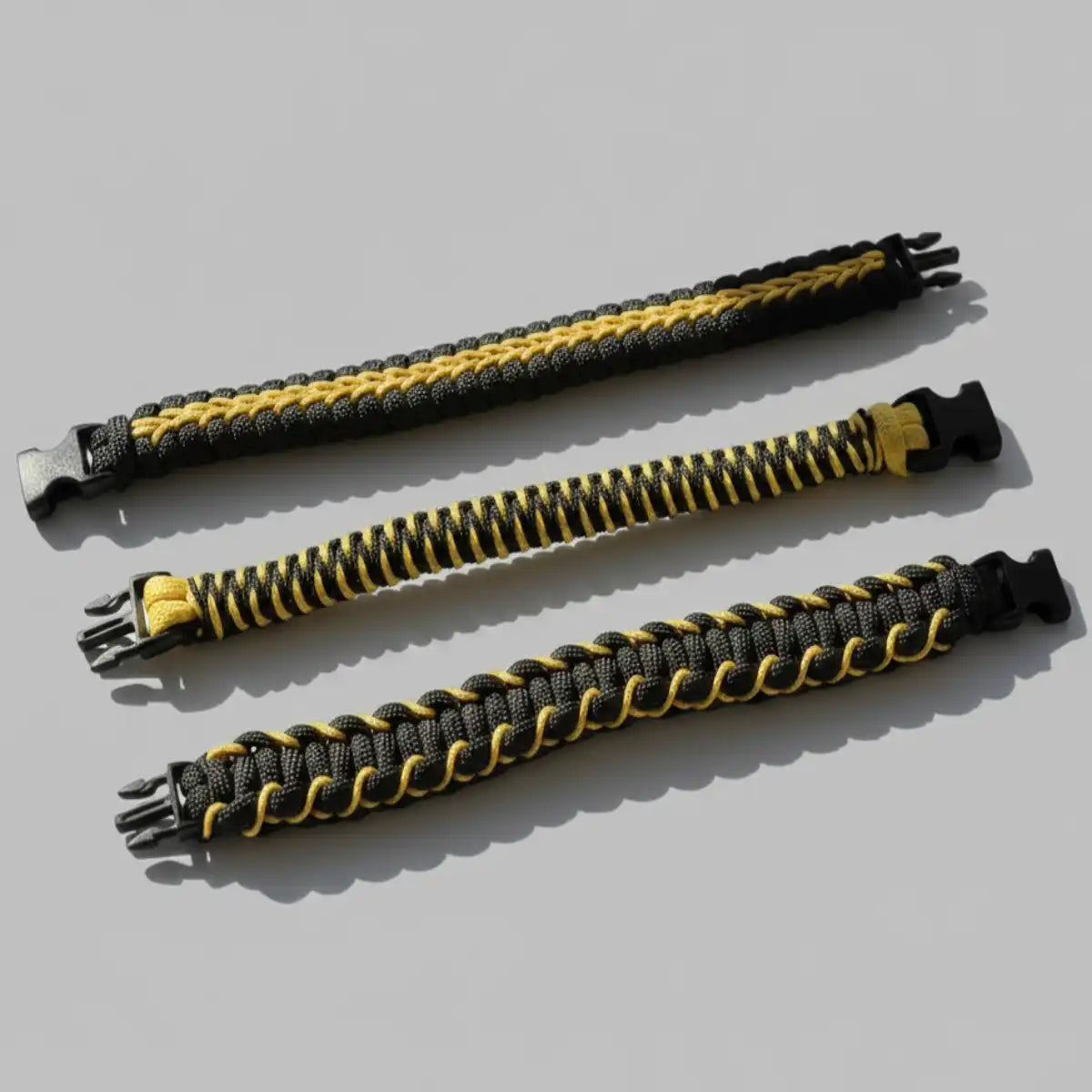 Tre bracciali Brooklyn Fitboxing in Paracord nero e giallo con intrecci differenti